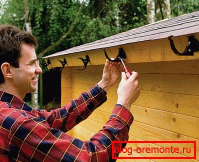 The brackets are attached to the board on the overhang of the roof