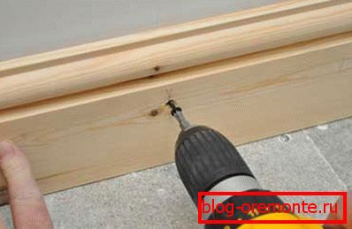 Fixing wooden baseboards with screws and wooden chopik, previously hammered into the wall Fixing wooden baseboards with screws and wooden chopik, previously hammered into the wall