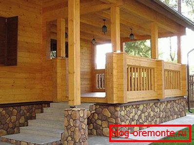 N photo of a wooden house with a veranda N photo of a wooden house with a veranda