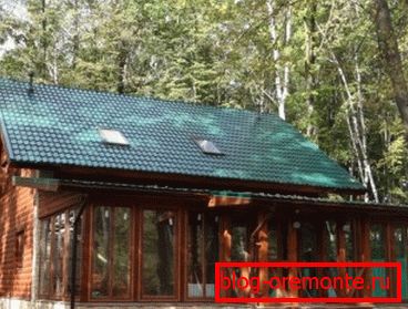 On the photo - bar-shaped house with a glazed veranda On the photo - bar-shaped house with a glazed veranda
