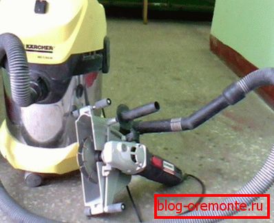 The photo shows a power tool in conjunction with an industrial vacuum cleaner. The photo shows a power tool in conjunction with an industrial vacuum cleaner.
