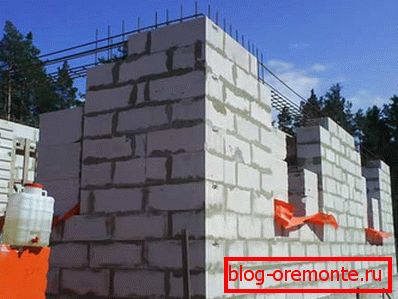 In the photo - the construction of load-bearing walls on a concrete foundation In the photo - the construction of load-bearing walls on a concrete foundation