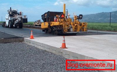 On the photo - docking of the concrete slab with asphalt On the photo - docking of the concrete slab with asphalt