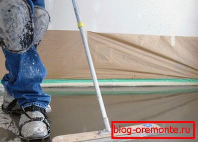 In the photo, a person does not wash the floor, but is engaged in its smoothing. In the photo, a person does not wash the floor, but is engaged in its smoothing.