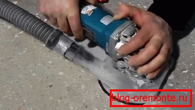 In the photo - manually grinding the concrete surface with dust removal In the photo - manually grinding the concrete surface with dust removal
