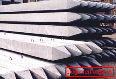 In the photo: ready-made concrete products - piles that require both delivery and installation using special equipment.