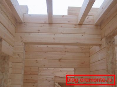 The photo shows a house of timber