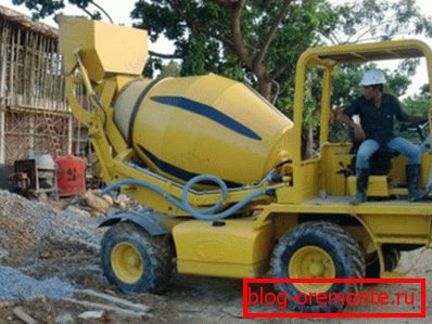 Small concrete mixer with a supply of concrete