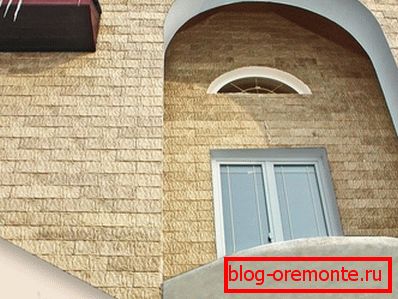 The facade of the building sheathed by a concrete siding The facade of the building sheathed by a concrete siding