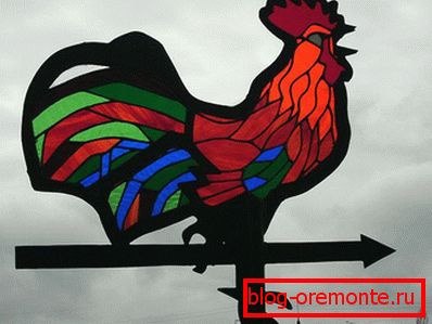 Rooster under the stained glass window