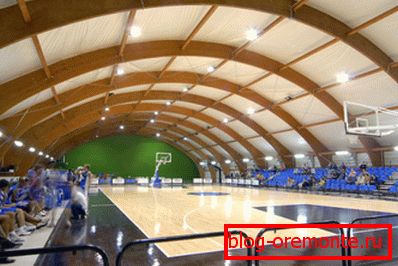 The use of flexible laminated timber construction as an arched ceiling of a sports complex. The use of flexible laminated timber construction as an arched ceiling of a sports complex.