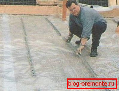 Laying the film on the sand and gravel pad Laying the film on the sand and gravel pad