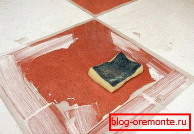 Grouting floor tiles